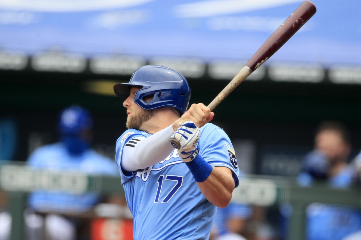 Kansas City Royals Hunter Dozier hits a two-run single during the first inning of a baseball game against the Minnesota Twins at Kauffman Stadium in Kansas City, Mo., Sunday, Aug. 9, 2020. (AP Photo/Orlin Wagner)
