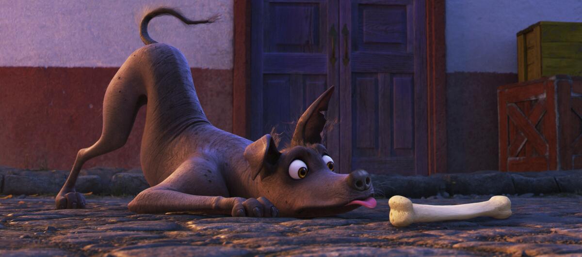 This image released by Disney-Pixar shows characters Miguel, voiced by Anthony Gonzalez, left, and Dante in a scene from the animated film, "Coco."