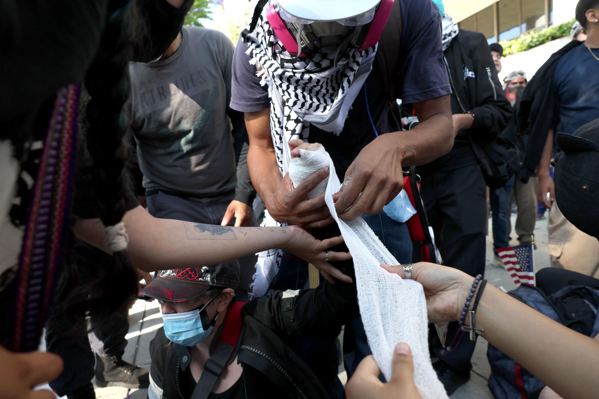 A protester gets treated after being injured at Los Angeles St. and Arcadia in Los Angeles, CA on June 8, 2025.