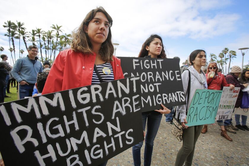 Top left: Francisca Verduzco, left, and her sister, Itzel Verduzco, center, hold signs supporting immigrant rights while attending March in Solidarity with Immigrants, San Diego. Top right: Kyle Fox, 4, and his father, Brady Fox, hold a sign at a vigil held to support the victims of the Chabad of Poway synagogue shooting. Bottom right: Emily Jones, right, and her daughters Tyra Neptune-Lucas, 12, second from right, and Lyssa Ballard, 16, center, hold signs on Espola Road to show support for Chabad of Poway. Bottom left: Kamri Jackson, center, holds up a sign as she and other people protest the Supreme Court’s decision to uphold Donald Trump's travel ban while in front of the Edward J. Schwartz Federal Building in San Diego.