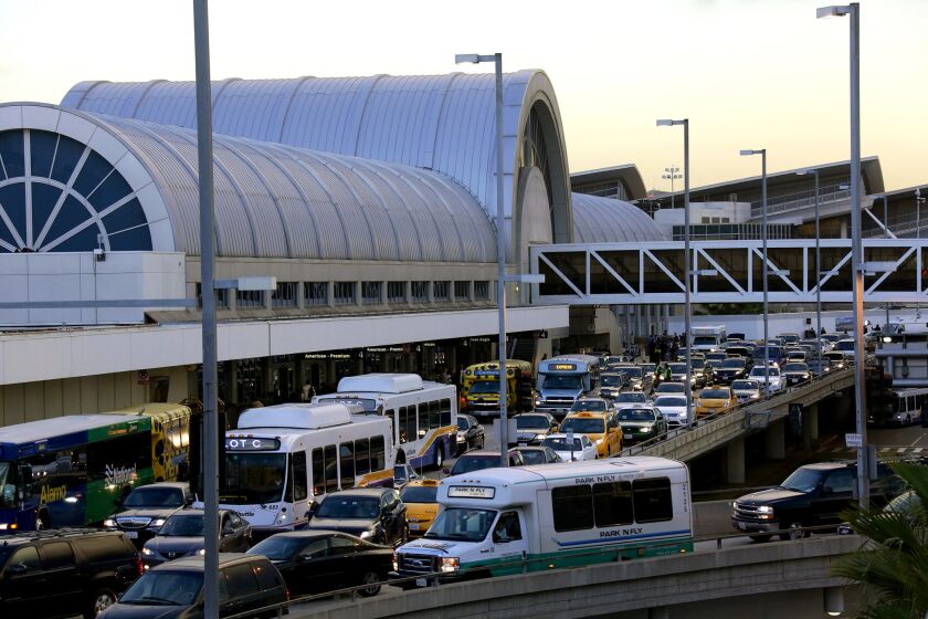 Cars, busses and vans pack the departure level outside LAX's Terminal 4. Ride-sharing services like Uber and Lyft cannot pick up arriving passengers at the airport.