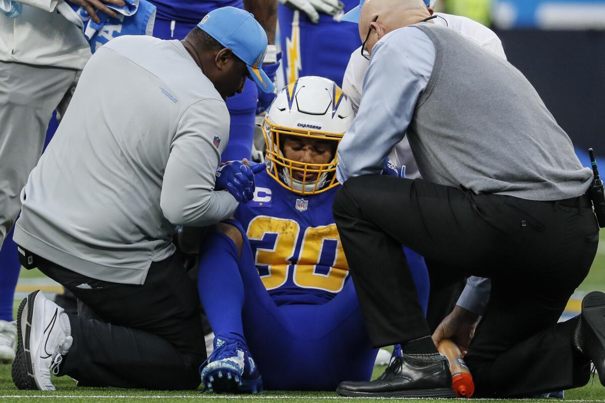 Chargers running back Austin Ekeler, who injured his ankle against the Giants, is helped off the field.