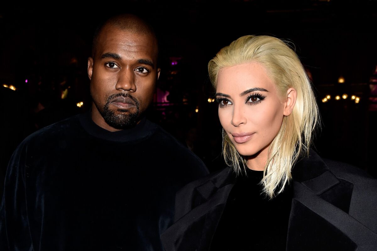 Newly blond Kim Kardashian and Kanye West attend the Balmain show as part of Paris Fashion Week on March 5.