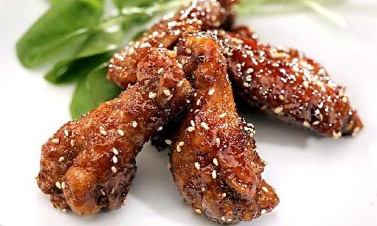 WHO NEEDS A DIPPING SAUCE? These deep-fried wings are glazed in a sticky-sweet soy reduction that gets its tang from fresh ginger.