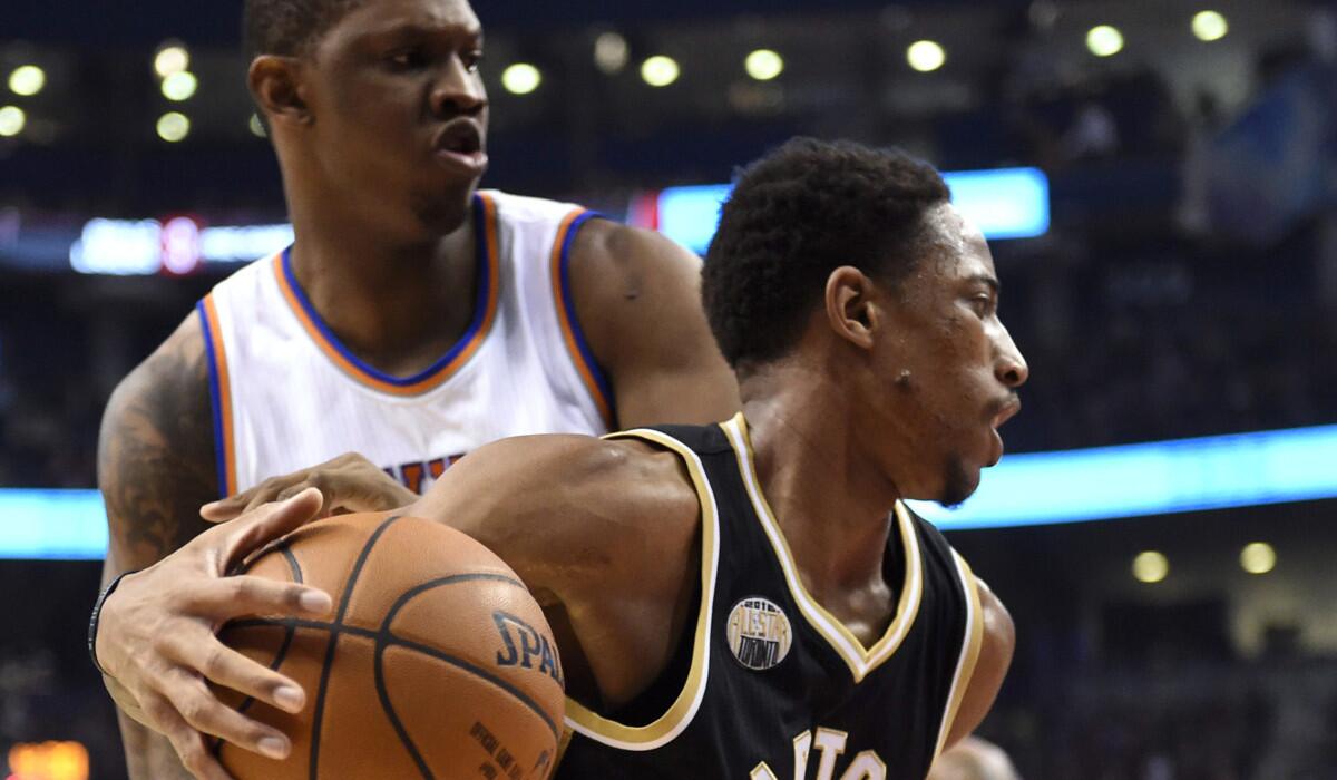 Toronto Raptors' DeMar DeRozan, right, drives past New York Knicks' Kevin Seraphin during the first half on Thursday.