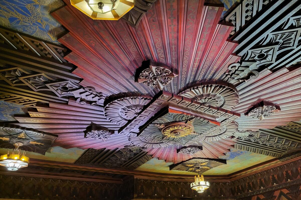 An ornate geometric ceiling design painted in floral colors.