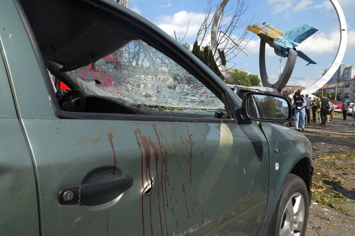 FILE - Blood stains are seen on a damaged car after a deadly Russian missile attack in Vinnytsia, Ukraine, July 14, 2022. As Russia's war in Ukraine rages on, the Kremlin is expanding its information war throughout Eastern Europe, spreading propaganda and disinformation blaming NATO and the West for its Ukraine invasion. (AP Photo/Efrem Lukatsky, File)