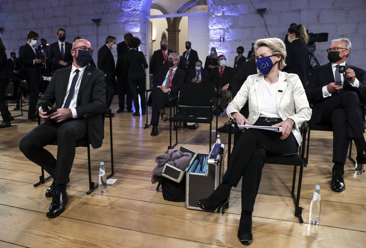European Commission President Ursula von der Leyen, right, and European Council President Charles Michel, left, wait for the start of the opening ceremony at an EU summit at the Alfandega do Porto Congress Center in Porto, Portugal, Friday, May 7, 2021. European Union leaders meet for a summit in Portugal on Friday, sending a signal they see the threat from COVID-19 on their continent as waning amid a quickening vaccine rollout. Their talks hope to repair some of the damage the coronavirus has caused in the bloc, in such areas as welfare and employment. (Tiago Petinga, Pool via AP)