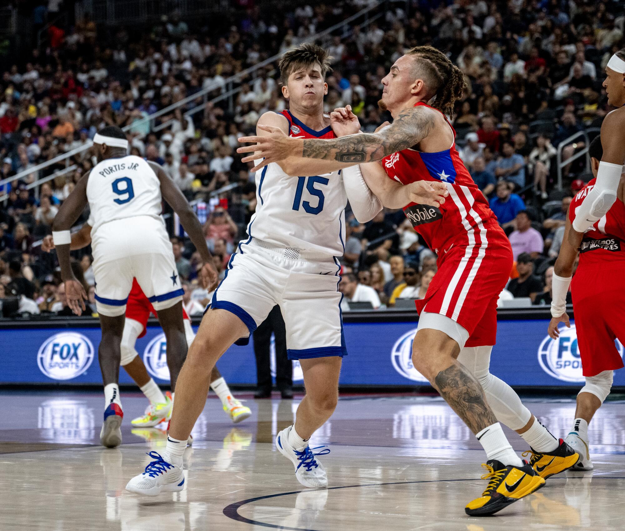 Team USA guard Austin Reaves battles for defensive position against Puerto Rico's Isaiah Pineiro during an exhibition game.