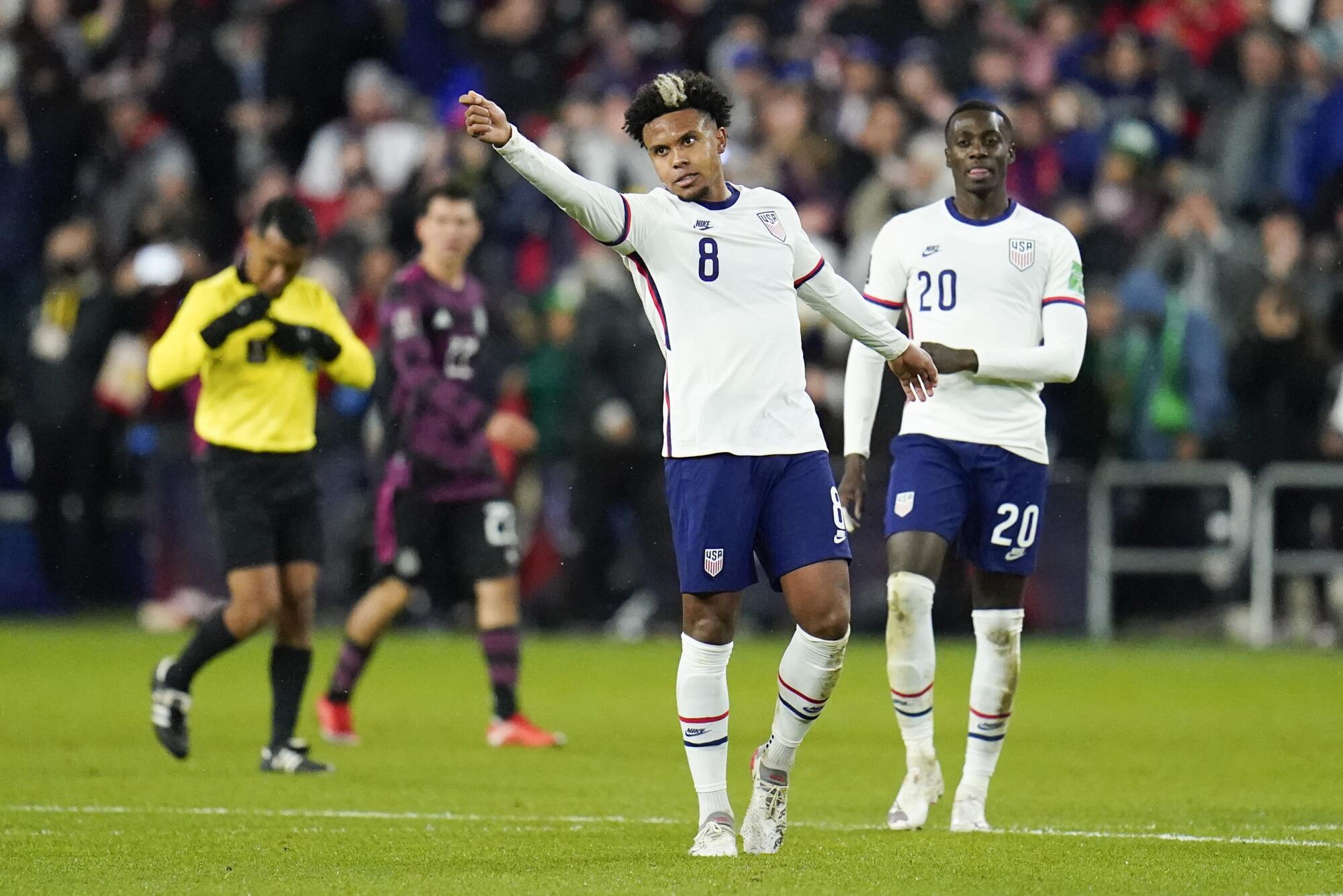 The United States' Weston McKennie reacts after scoring a goal as teammate Tim Weah looks on