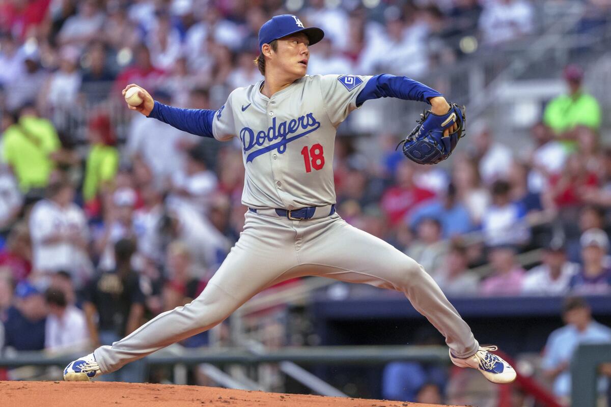 Dodgers pitcher Yoshinobu Yamamoto delivers against the Atlanta Braves at Truist Park.