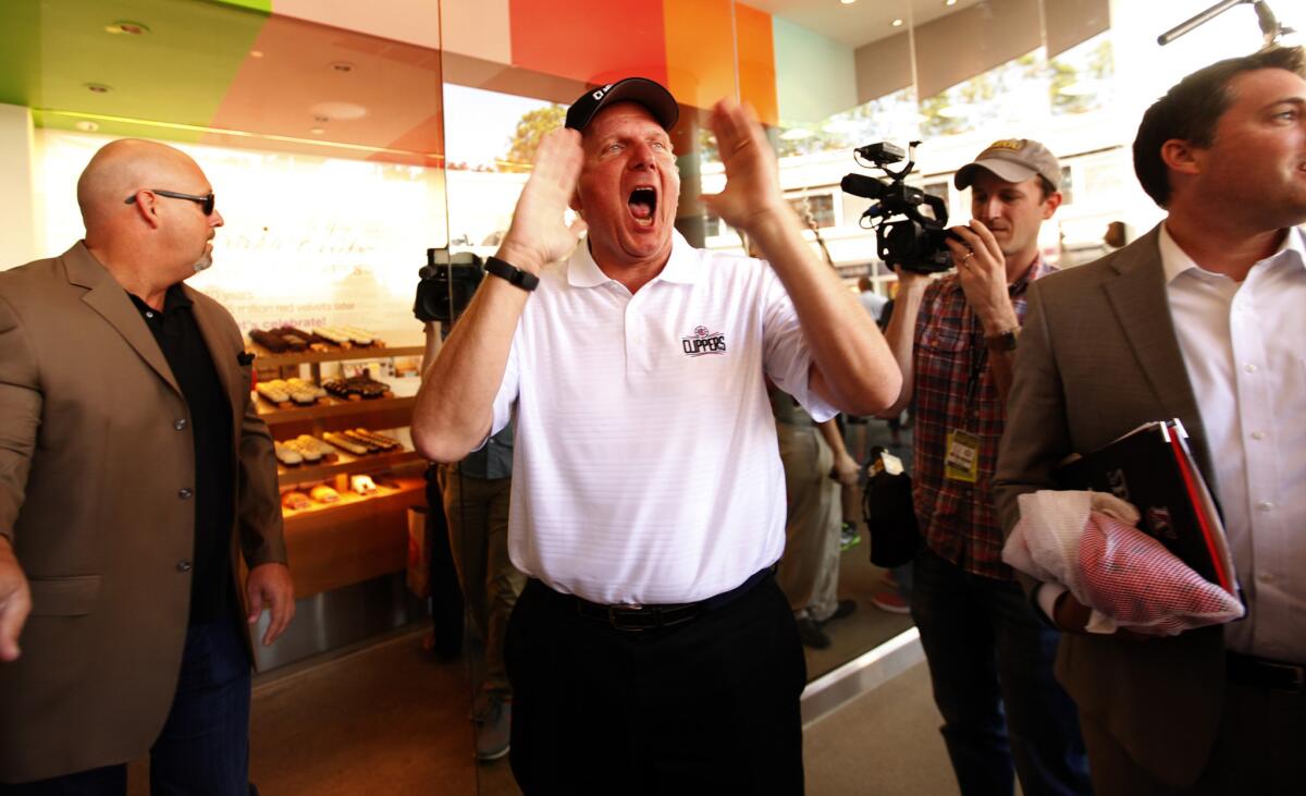 Clippers Owner Steve Ballmer shouts to fans at Sprinkles Cupcakes in downtown Los Angeles as part of his team's rebranding campaign and official launch of its new logos.