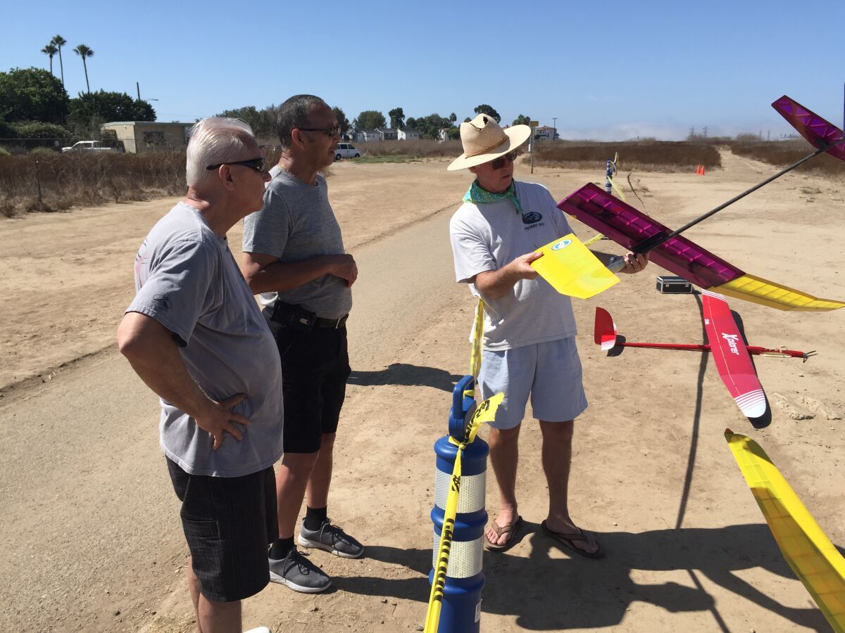 Chris Adamczyk attaches a wing to his glider at Costa Mesa's Fairview Park model airplane flying field in 2019.