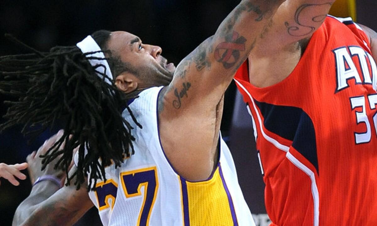 Lakers center Jordan Hill goes up to block a shot during the Lakers' 105-103 win Sunday at Staples Center.