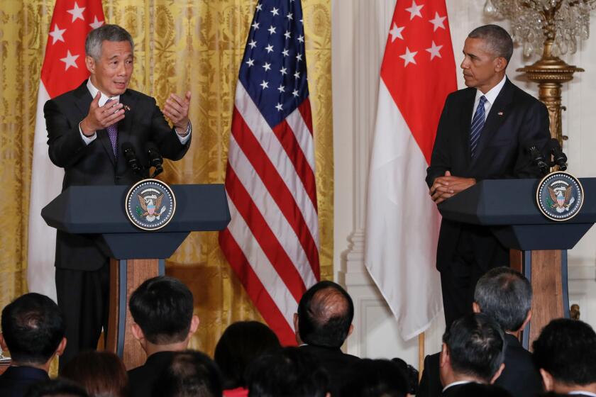 President Barack Obama listens as Singapore's Prime Minister Lee Hsien Loong speaks during their joint news conference at the White House on Aug. 2. The Trans-Pacific Partnership was high on the agenda during the Prime Minister's visit to Washington.