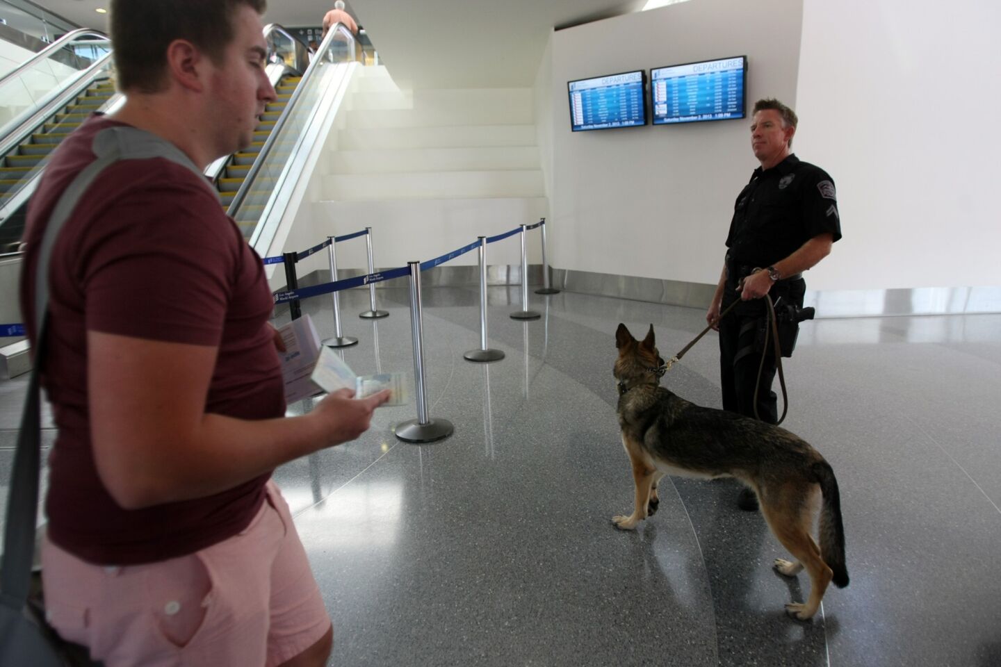 Los Angeles Airport Police Officer Dan Keehne and his canine partner keep an eye on passengers in Terminal 3.