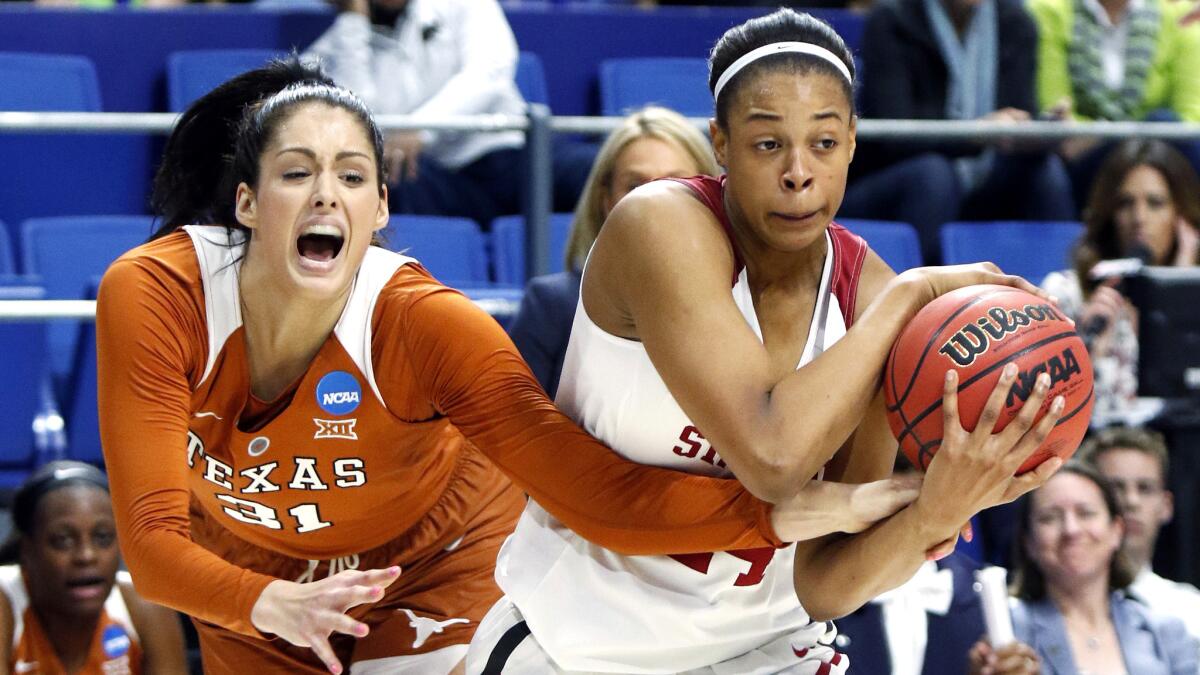 Stanford center Erica McCall tries to protect the ball as she's pressured by Texas forward Audrey-Ann Caron-Goudreau during a regional semifinal Friday night. (James Crisp / Associated Press)