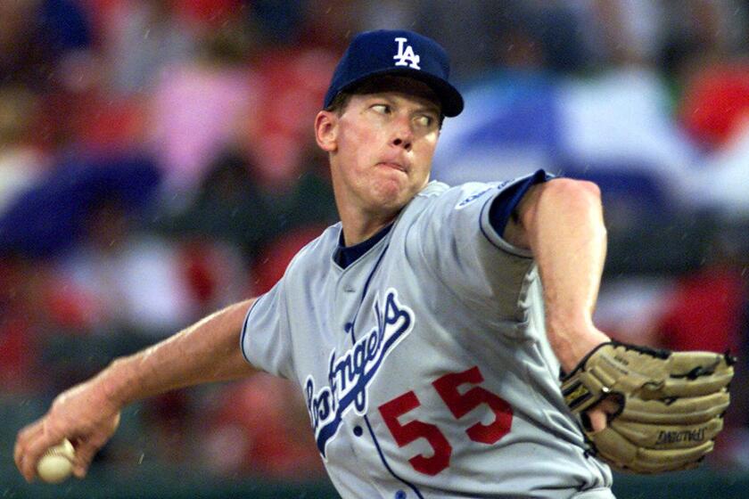 FILE––Los Angeles Dodgers' Orel Hershiser pitches in the rain during the second inning against the St. Louis Cardinals, June 24, 2000, in St. Louis. Hershiser, waived by the Dodgers last week after one of the worst outings of his career, announced Thursday, July 6, 2000, that he is retiring. The 1988 NL Cy Young winner and World Series MVP with the Dodgers, Hershiser struggled after rejoining the club as a free agent last winter. His ERA was 13.14 in 10 appearances, including six starts, but totaled just 24 2–3 innings. (AP Photo/Tom Gannam)
