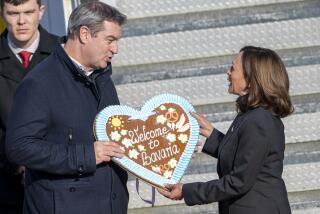 dpatop - 15 February 2024, Bavaria, Munich: Markus S'der, (CSU) Prime Minister of Bavaria, receives US Vice President Kamala Harris at Munich Airport with an oversized gingerbread heart with the inscription "Welcome to Bavaria" as a guest of the Munich Security Conference. Photo by: Peter Kneffel/picture-alliance/dpa/AP Images