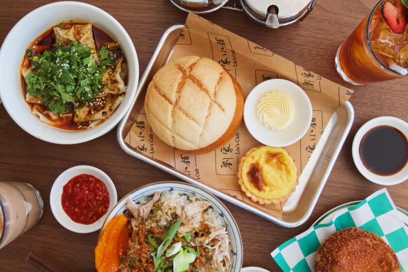 An overhead of food and tea from Liu's Cafe in Koreatown, including Chiayi chicken rice, wontons in chile oil, pineapple bun