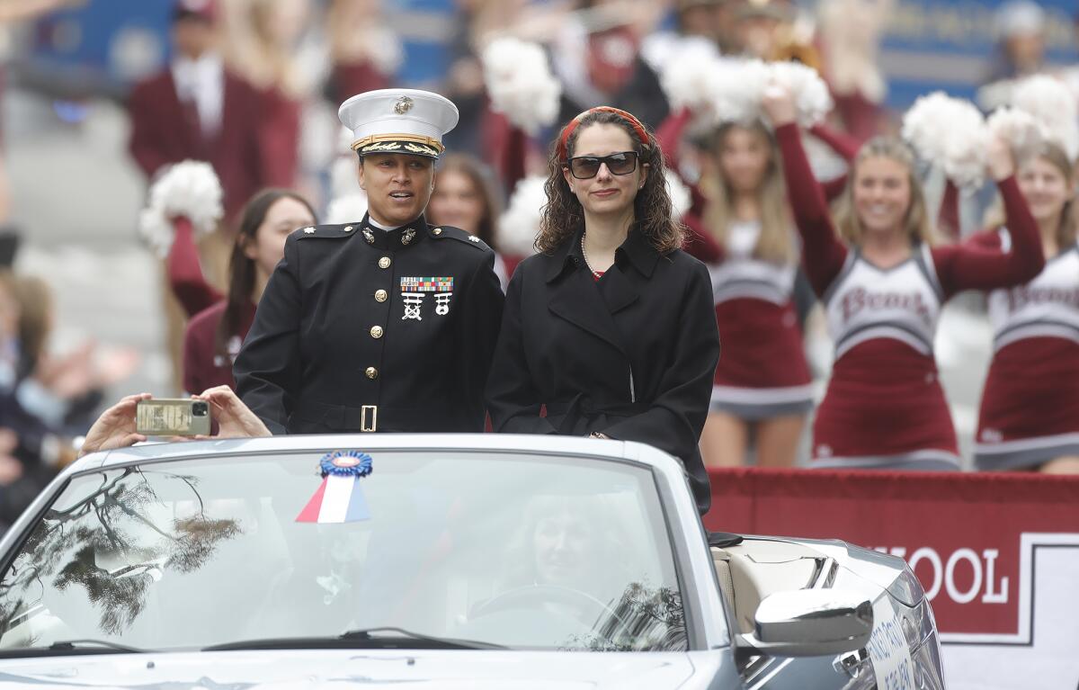 Honored Patriot Maj. Erin Bevacqua, USMC, left, rides in the 56th annual Patriots Day Parade in Laguna Beach on Saturday.