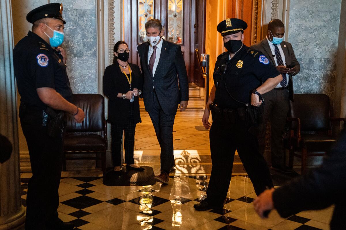 Sen. Joe Manchin walks through the Capitol halls