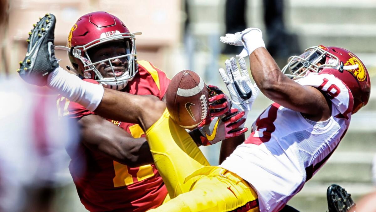 Cornerback Jalen Jones, left, breaks up an end-zone pass intended for receiver Josh Imatorbhebhe during USC's spring football game Saturday at the Coliseum.