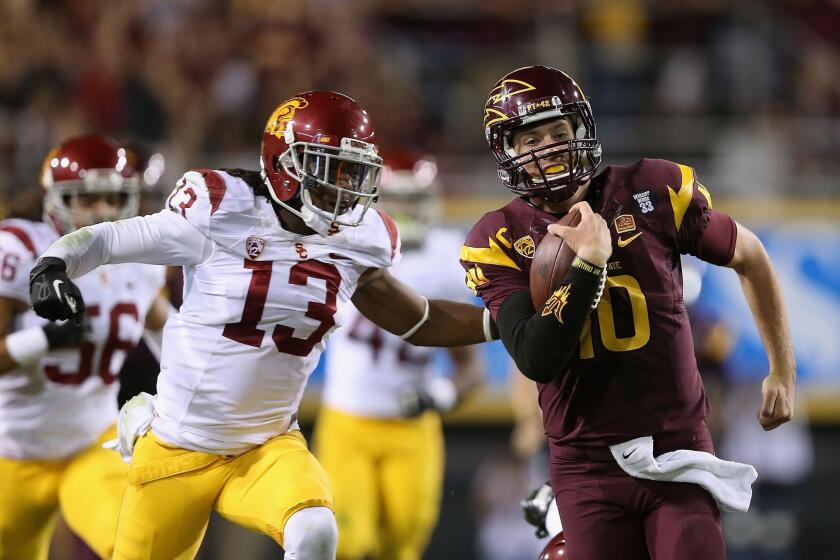 USC cornerback Kevon Seymour, left, chases down Arizona State quarterback Taylor Kelly during a game last month. Seymour expects to see plenty of passes thrown his way against Oregon State on Friday.