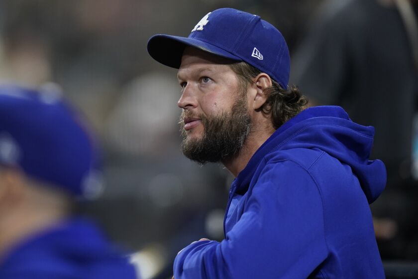 Los Angeles Dodgers starting pitcher Clayton Kershaw looks on from the dugout during the fourth inning.