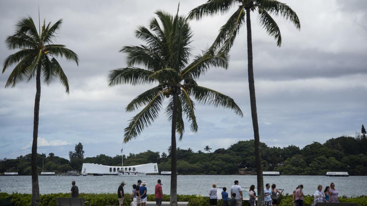 Visitors view the USS Arizona Memorial on Thursday in Pearl Harbor.