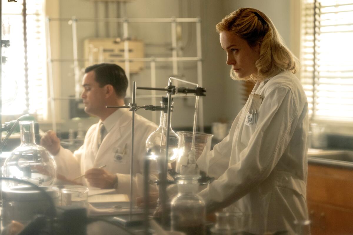 A man and woman work in a chemistry lab in "Lessons in Chemistry."