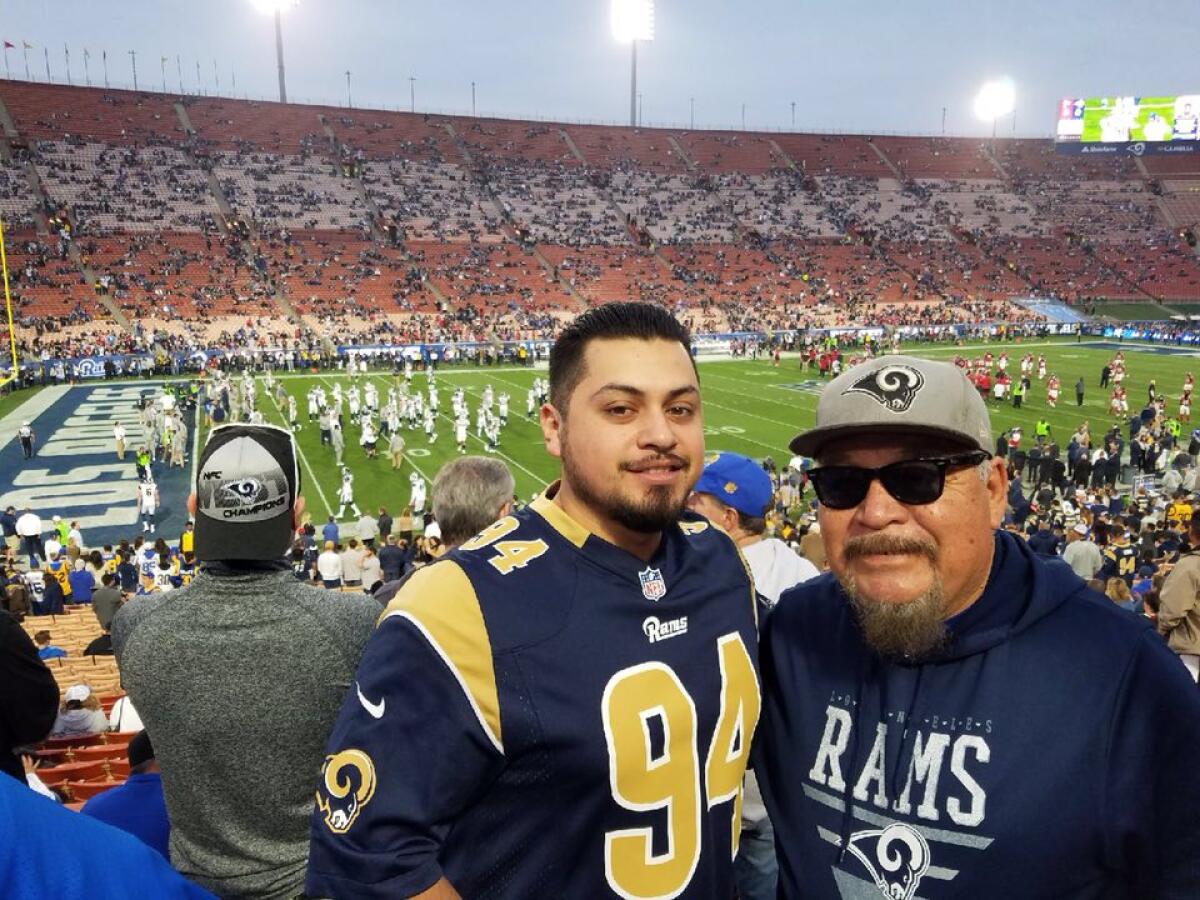 Paul Martinez with grandson Michael, who said his father “believed sports were a way of bringing family together.”