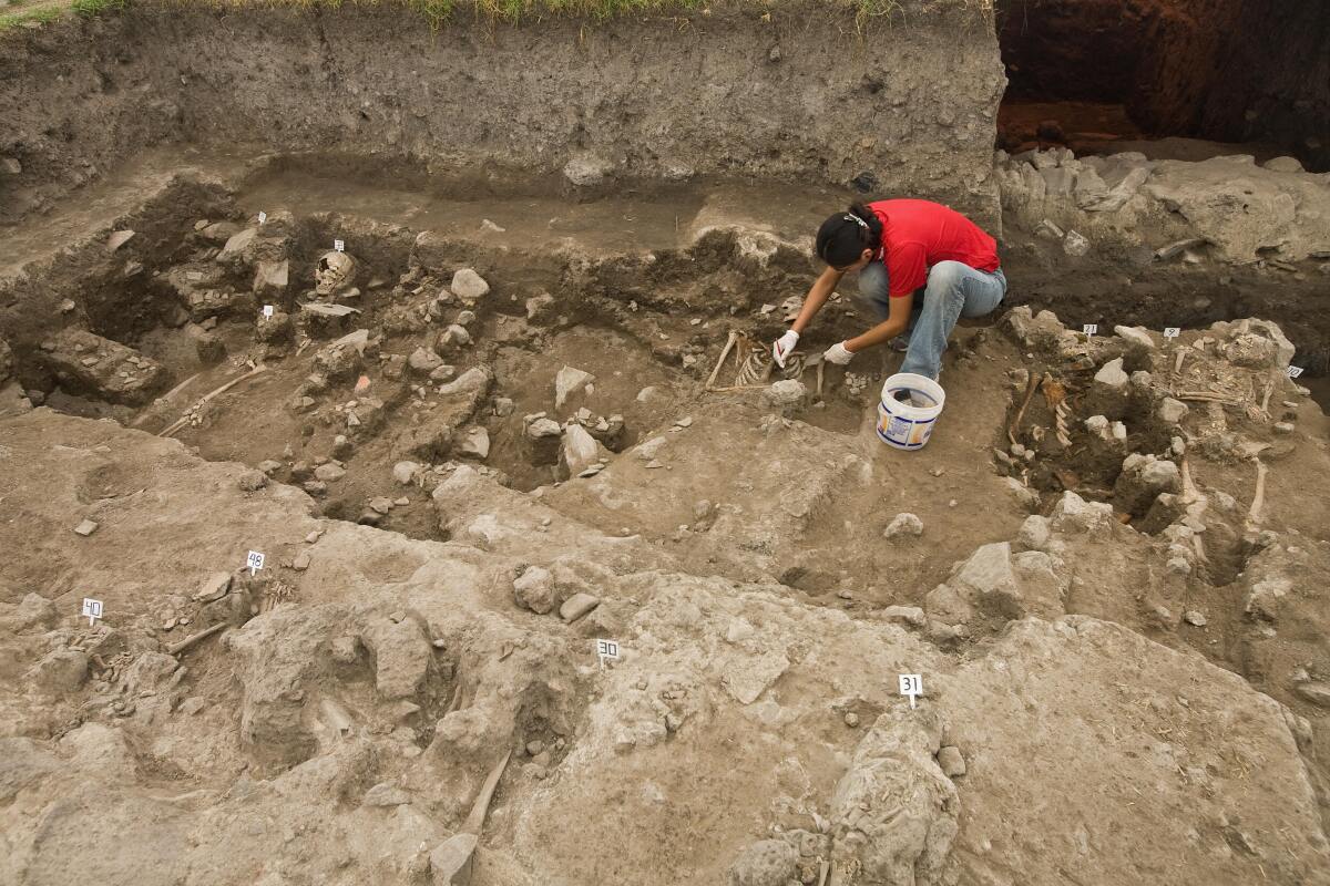 An archaeologist works on the site where a cemetery was found at Tlatelolco square in Mexico City.