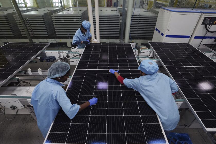 Machine operators clean solar panels at the Premier Energies Solar on the outskirts of Hyderabad, India, Wednesday, Jan. 25, 2023. Over 500 energy industry heavyweights will descend on the southern Indian city of Bengaluru on Monday, Feb. 6, 2023, to discuss the future of renewables and fossil fuels at India Energy Week — the first big ticket event of the country's presidency of Group of 20 leading economies. (AP Photo/Mahesh Kumar A.)