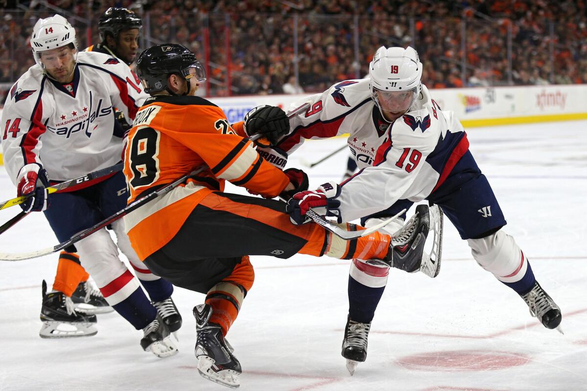 Capitals' Nicklas Backstrom (19) checks Flyers center Claude Giroux (28) during the third period on Mar. 30.