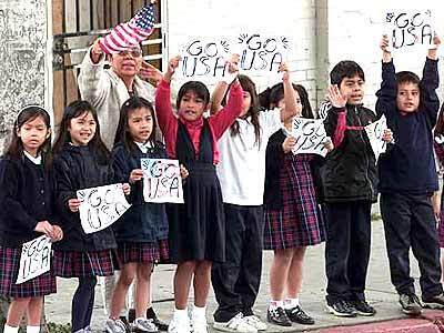 Young children hold signs