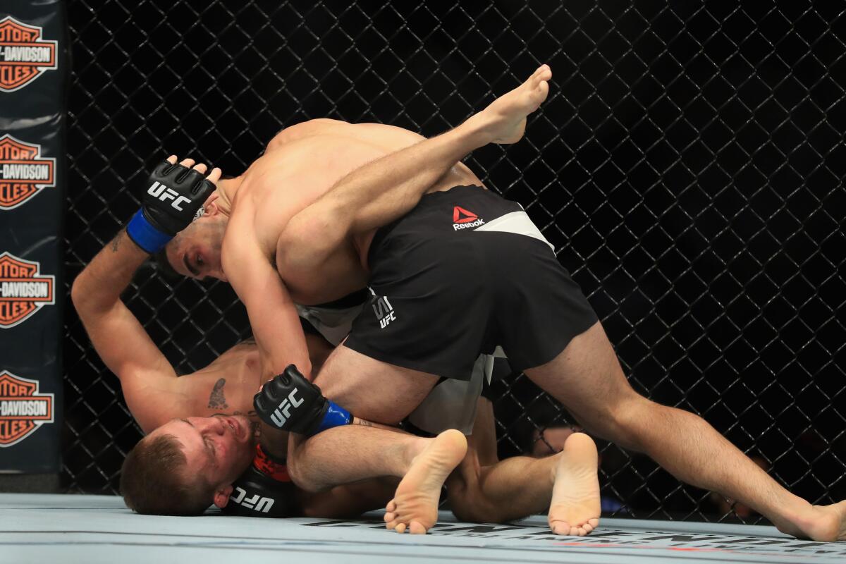 Ricardo Lamas delivers the decisive blows to defeat Jason Knight by TKO during their featherweight fight at UFC 214.