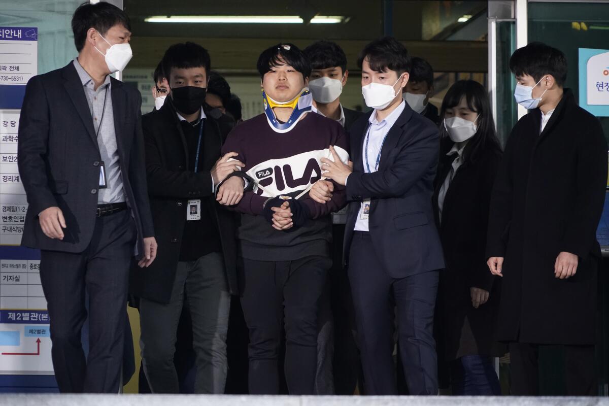 Suspect Cho Ju-bin, center, is paraded before journalists at a police station in Seoul. The allegations have triggered soul-searching over a culture that critics say is lenient about sexual violence.