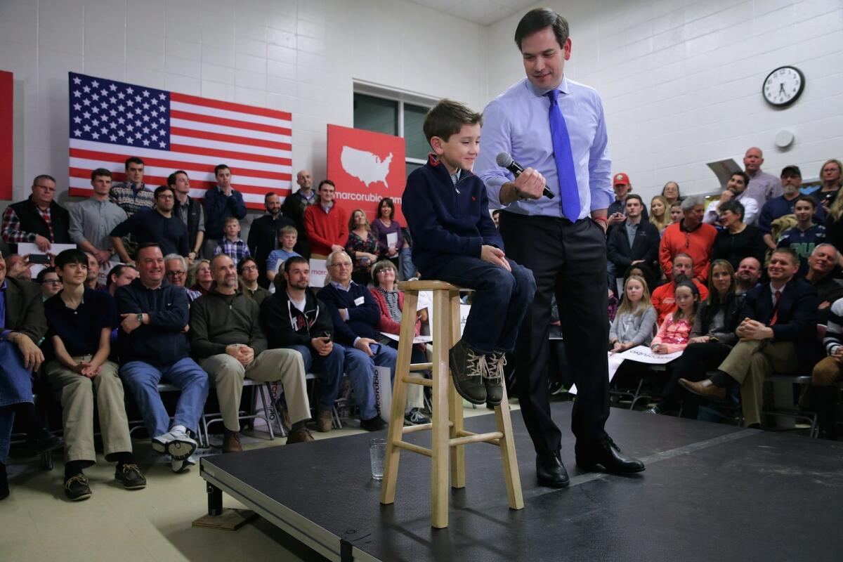 Dominick Rubio, 7, joins his father Marco Rubio on stage during a campaign town hall event at Mary A. Fisk Elementary School in Salem, N.H. Feb. 4.