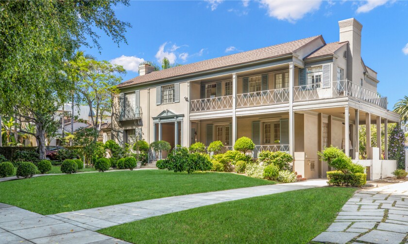 The two side-by-side estates include a 1930s Traditional-style home and 1920s Spanish-style home.