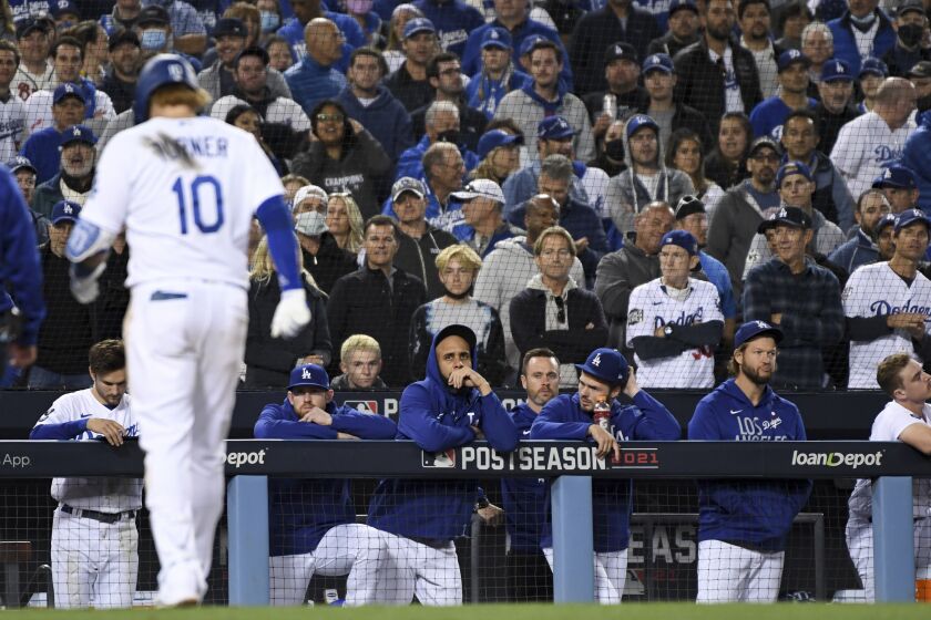 Los Angeles, CA - October 20: The Los Angeles Dodgers bench watches after Justin Turner walks to the dugout.