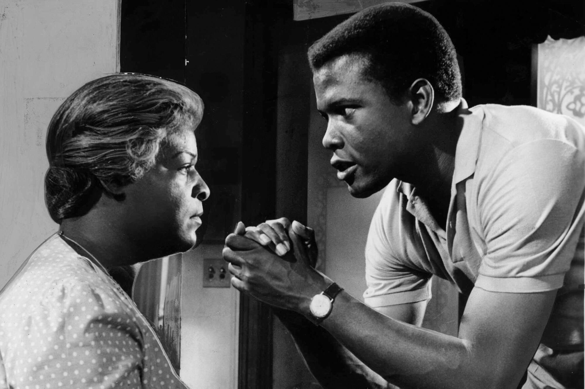 Sidney Poitier, right, in a scene with Claudia McNeil, right, from the film adaptation of "Raisin in the Sun."