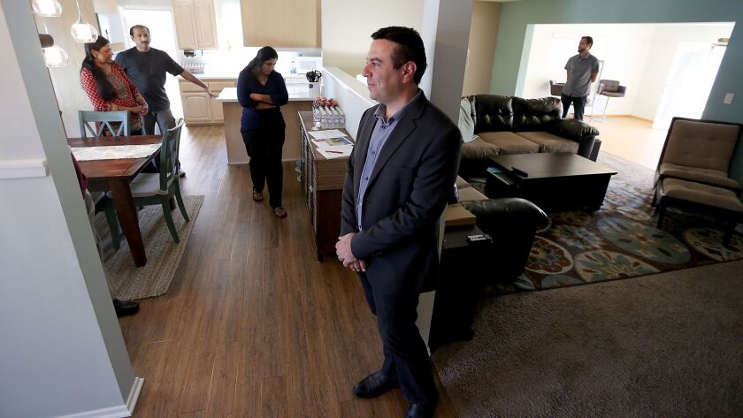 Real estate agent Hooman Zahedi holds an open house this month at a three-bedroom residence in Canoga Park.