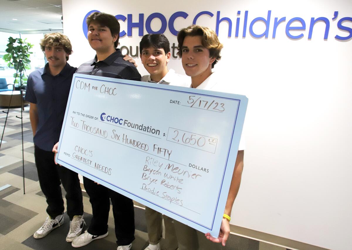 Bryson White, left, Bodie Staples, Bryce Roberts and Riley Meunier hold a check for $2,650 they raised for CHOC.