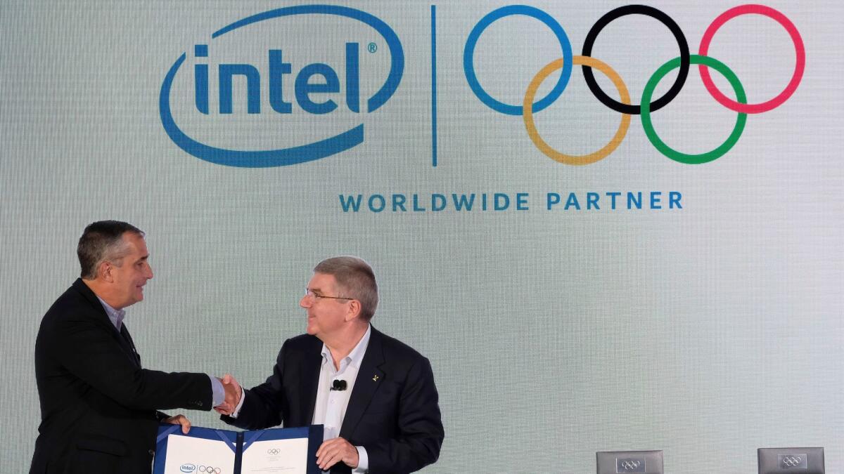 Intel CEO Brian Krzanich, left, and International Olympic Committee President Thomas Bach shake hands after signing the agreement making Intel an partner of the IOC through the 2024 Olympic Games.
