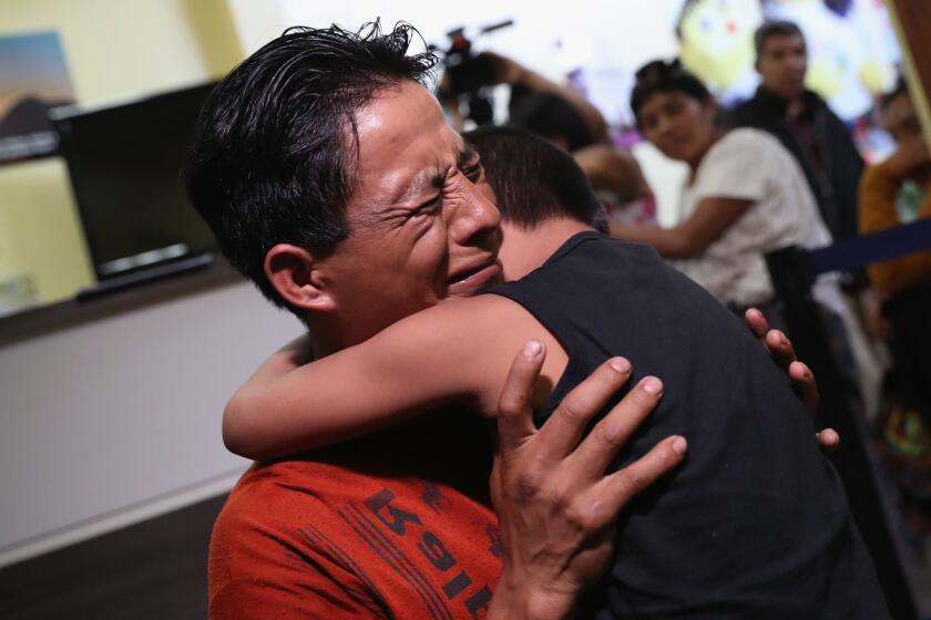 GUATEMALA CITY, GUATEMALA - AUGUST 07: An emotional father embraces his son for the first time in months on August 7, 2018 in Guatemala City, Guatemala. A group of nine children were flown from New York and reunited with their families, months after U.S. border agents separated them and deported the parents as part of the Trump administration's "zero tolerance" policy at the border. Most of the children had been held at the Cayuga Center in New York City. (Photo by John Moore/Getty Images) *** BESTPIX *** ** OUTS - ELSENT, FPG, CM - OUTS * NM, PH, VA if sourced by CT, LA or MoD **