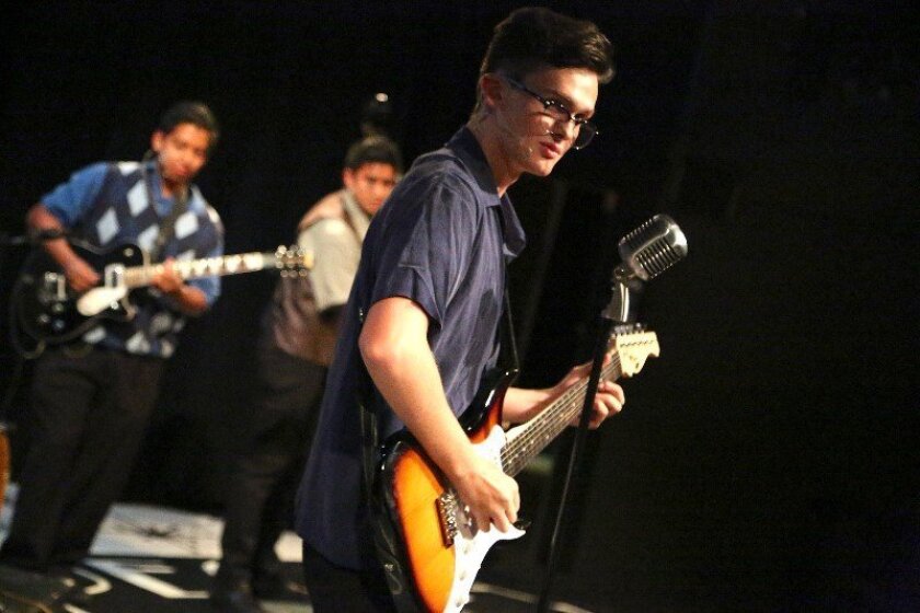 Noah Zuniga-Williams (with Carlos Hernandez and Austin Gatus, background) in OnStage Playhouse's "The Buddy Holly Story."