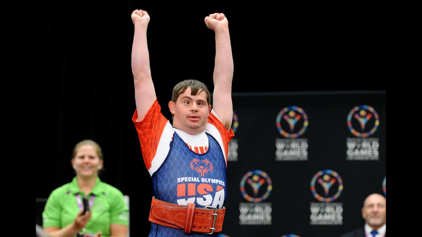 USA's Thomas Baker raises his arms after completing a dead lift to win the gold medal in the powerlifting combination competition in Los Angeles on July 28.
