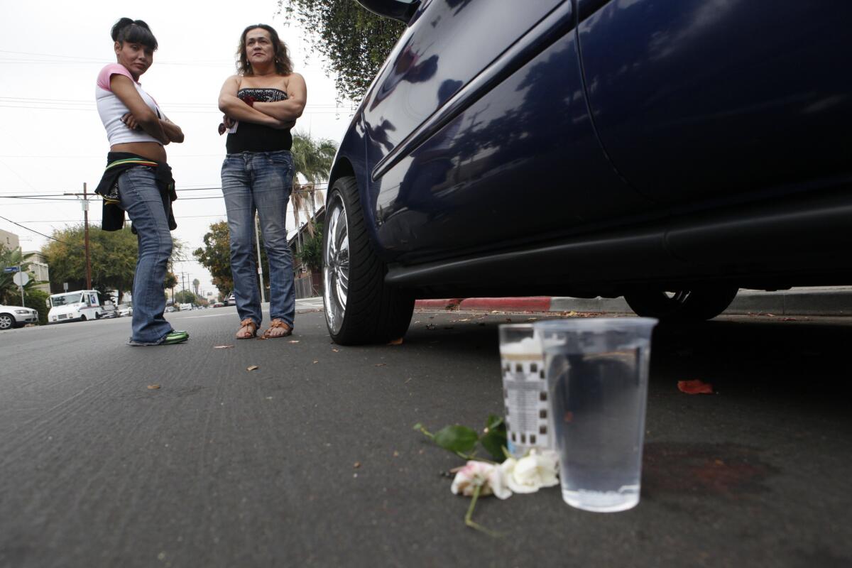 Laura and Valerie stand by the bloodstained spot where Nathan Vicker, a transgender man, was shot and killed in 2011 near Gower Street and Lexington Avenue in Hollywood.