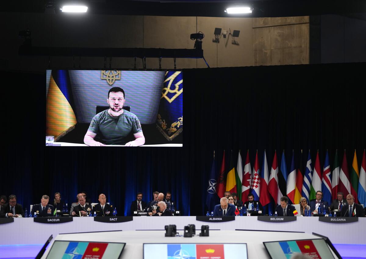 Ukrainian President Volodymyr Zelensky onscreen addressing NATO summit
